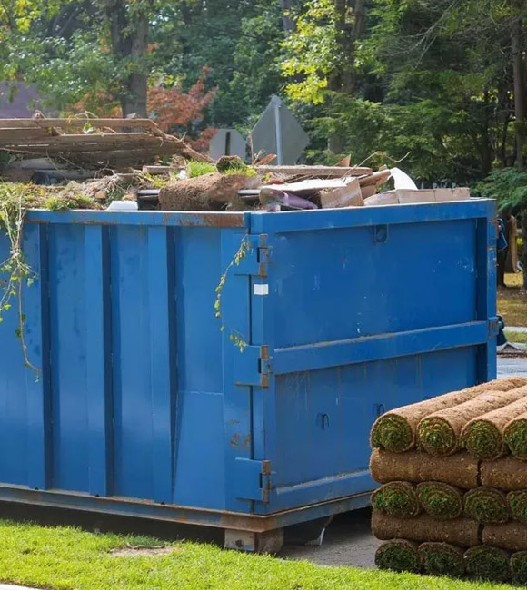 dumpster filled with yard waste