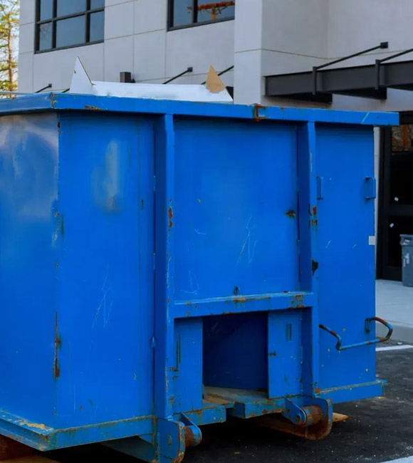 blue dumpster outside of building